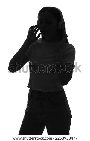 Silhouette of young woman in headphones on white background