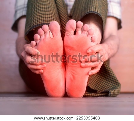 Tingling and burning sensation in foot of Asian elder man with diabetes. Foot pain. Sensory neuropathy problems. Foot nerves problems. Plantar fasciitis.