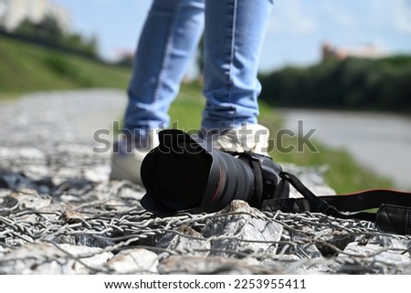 a woman photographer with a camera in her haa woman photographer with a camera in her hands walks through the streets of the citynds walks through the streets of the city