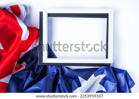 Australia Day greeting card Background with  australian flag, silver stars, paper red, blue, white decor, over white background, frame copy space