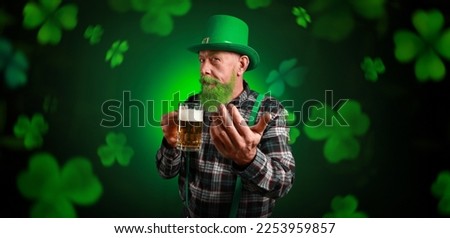 Bearded man with beer on dark background. Banner for St. Patrick's Day 
