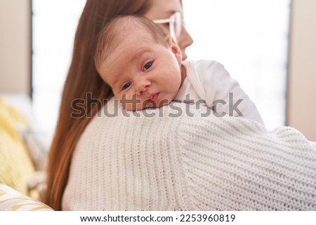 Mother and son hugging each other standing at home Royalty-Free Stock Photo #2253960819