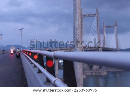 The red road guardrail reflector serves to reflect light exposure from the vehicle so that it knows the road boundary and is usually installed on the side of the guardrail. Royalty-Free Stock Photo #2253960995