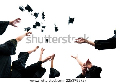 Graduating students hands throwing graduation caps on white background. Royalty-Free Stock Photo #2253983927