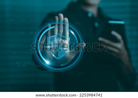 Data protection concept, businessman raising hand showing stop sign And there is a data protection symbol graphic on the palm.