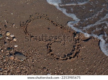 Heart Symbol On a Sand Of Beach With Soft Wave On Background