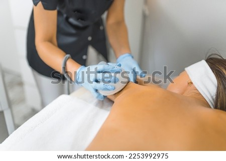 Latin American woman getting a back and arms massage in beauty clinic. High quality photo