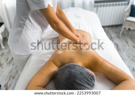Beautiful woman getting a back massage in spa. High quality photo