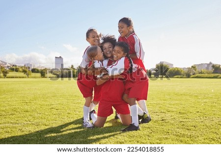 Success, soccer or winner children team hug in stadium for sports exercise, sport game or workout training. Teamwork, Canada or kids in celebrating fitness, wellness or health goal on football field Royalty-Free Stock Photo #2254018855