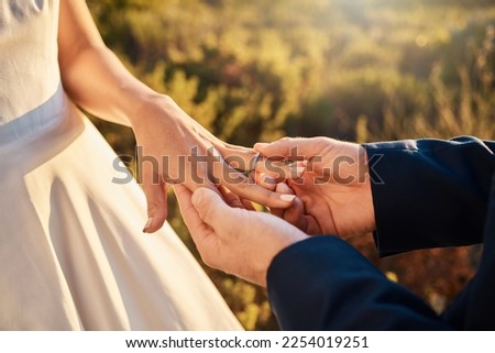 Hands, wedding couple and ring at ceremony outdoor with jewelry and save the date announcement. Engagement, love together and marriage of people in nature at life commitment and engagement event Royalty-Free Stock Photo #2254019251