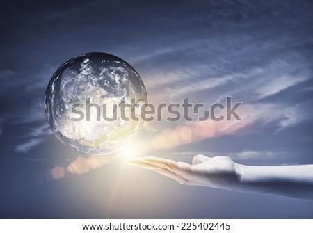 Human hand holding Earth planet. Elements of this image are furnished by NASA
