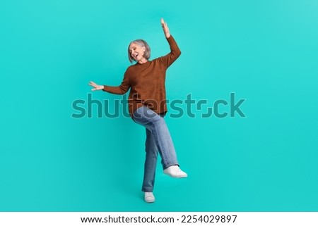 Full body photo of pretty positive aged lady feel young dancing clubbing isolated on teal color background