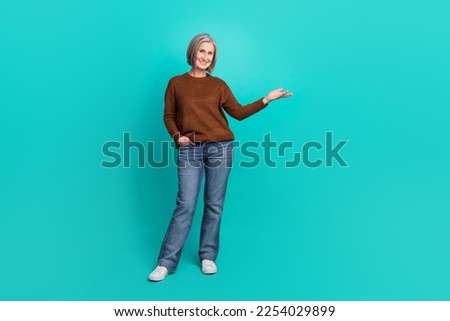 Full size photo of charming cheerful person hand hold empty space isolated on turquoise color background