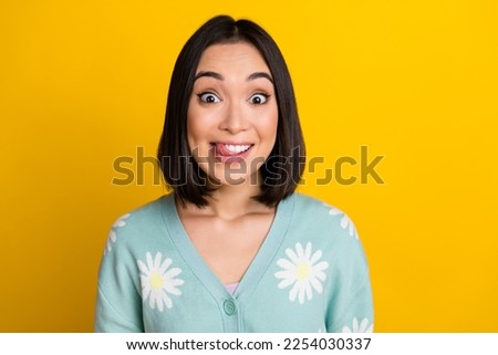 Photo of good mood astonished nice woman with bob hairdo dressed blue pullover staring lick teeth isolated on yellow color background Royalty-Free Stock Photo #2254030337