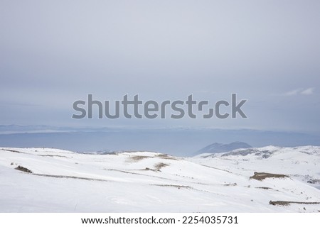 Snow-covered mountains in a European ski resort against a blue cloudy sky. Nature, beautiful views.  Vacation. Travel content