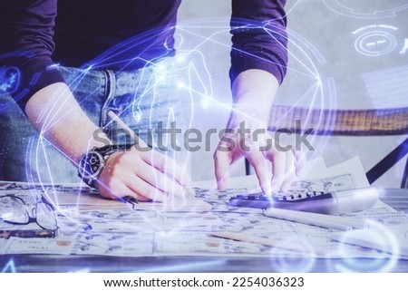 Man's hands working with notes background. Modern computer record diagram with virtual mnitor. Education concept. Double exposure.