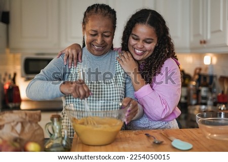 African mother and daughter cooking together at home Royalty-Free Stock Photo #2254050015