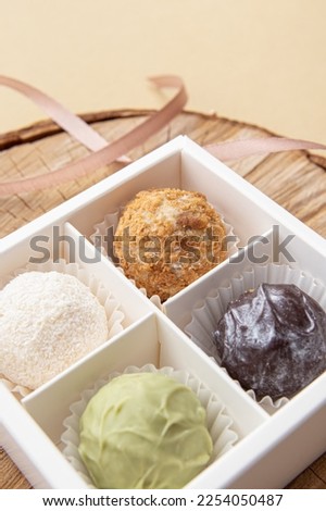 Healthy handmade chocolate candies in white box. Four cheese truffles. Soft focus. Sweet gift