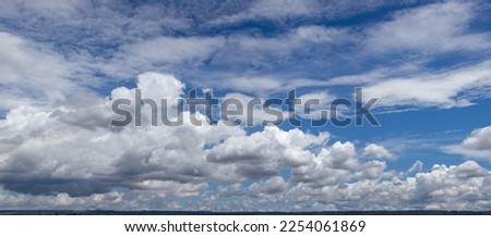 Wide blue sky with clouds and blur in depth of field to the horizon line. Special for changing the sky in photo editing