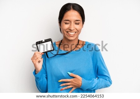 hispanic pretty woman laughing out loud at some hilarious joke. vip pass card id