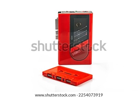 Beautiful red vintage audio cassette player over white background Royalty-Free Stock Photo #2254073919