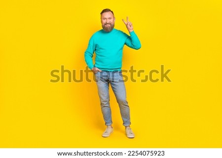 Full size photo of handsome granddad showing v-sign posing banner wear trendy aquamarine clothes isolated on yellow color background