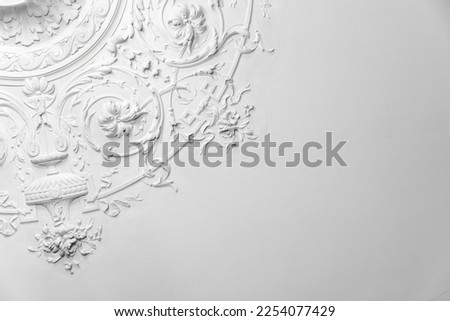 White gypsum bas-relief ceiling design elements in rococo style, classic architecture abstract template Royalty-Free Stock Photo #2254077429