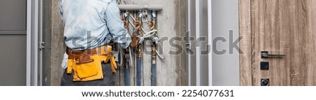 Plumber Repairing Water Pipes In Residential Building