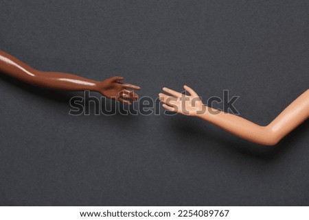 Doll hands on a gray background. Help, friendship concept Royalty-Free Stock Photo #2254089767