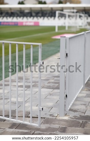 the fence of the football field is a folded wicket