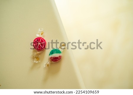 Two colored candies with a white background.