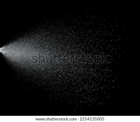 Million of Star Dust, Photo image of falling down shower rain snow, heavy snows storm flying. Freeze shot on black background isolated overlay. Spray water fog smoke as star particle on wind Royalty-Free Stock Photo #2254135005