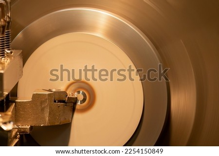 The lathe machine finish cut the brass parts by lathe tools. The metalworking process by turning machine.