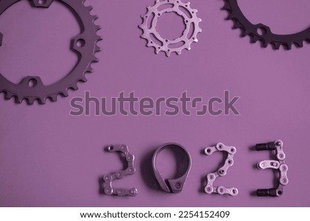 2023 number from bicycles parts on purple violet effect background