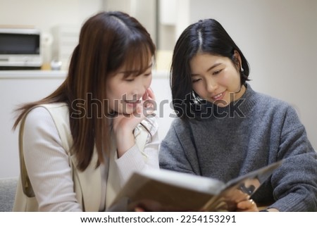 Image of a woman looking at an album

