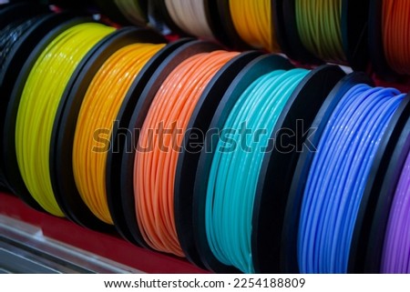 Many multi-colored spools of thread of filament for printing 3d printer. Material coils for printing 3D printer. Spools of 3D printing motley different colors filament. ABS wire plastic for 3d printer Royalty-Free Stock Photo #2254188809