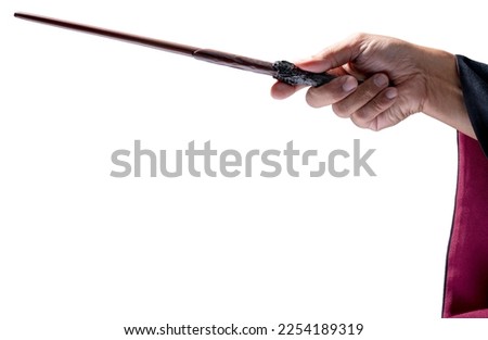 Hand holding Magic wand Wizard tool isolate on white background With clipping path. Royalty-Free Stock Photo #2254189319