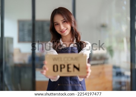 Beautiful female manager in restaurant with tablet. Man coffee shop owner with open sign. Small business concept