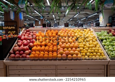 Various type of fresh fruits arrange neatly grocery store. Apple, Orange, Pomegranate, Lemon on rack.  Royalty-Free Stock Photo #2254210965