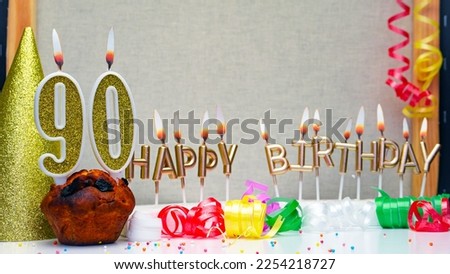 Happy birthday background with golden candles and decorations with candles burning number  90. Colorful festive card happy birthday with a number. Anniversary copy space