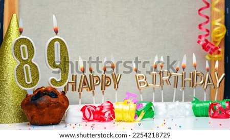 Happy birthday background with golden candles and decorations with candles burning number  89. Colorful festive card happy birthday with a number. Anniversary copy space