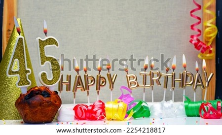 Happy birthday background with golden candles and decorations with candles burning number  45. Colorful festive card happy birthday with a number. Anniversary copy space