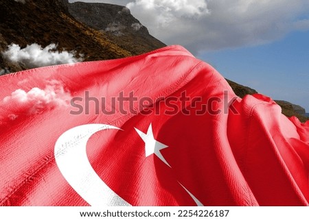 Turkey national flag cloth fabric waving on beautiful mountain background.