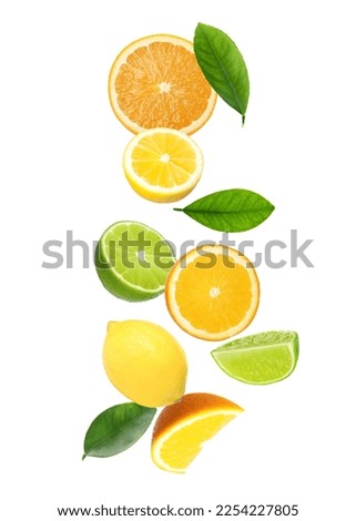 Different fresh citrus fruits and leaves falling on white background Royalty-Free Stock Photo #2254227805