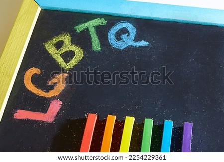A painted rainbow on a chalkboard. Copy space. The concept of LGBT