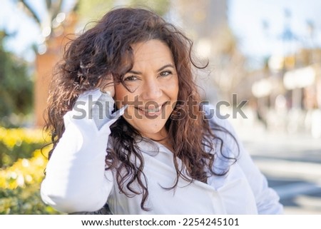 Woman Smiling. Happy Woman Enjoying A Spring Day In A City Park. Royalty-Free Stock Photo #2254245101