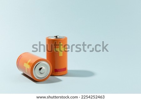 Batteries isolated on cyan, energy concept Royalty-Free Stock Photo #2254252463