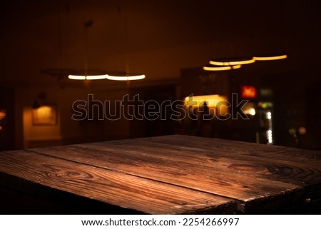 Image of wooden table in front of cafe restaurant abstract blur background