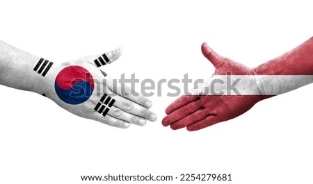 Handshake between South Korea and Latvia flags painted on hands, isolated transparent image.