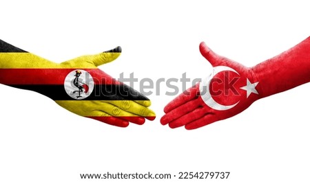 Handshake between Turkey and Uganda flags painted on hands, isolated transparent image.